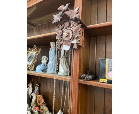 A cuckoo clock with weights 