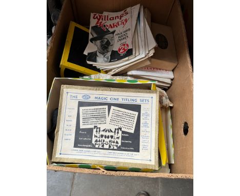 A box of vintage magic tricks and various magic ephemera.