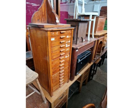 Various items of furniture; an oak desk, a set of vintage oak filing drawers, a pitch pine wall sconce, a rustic stool, a whi