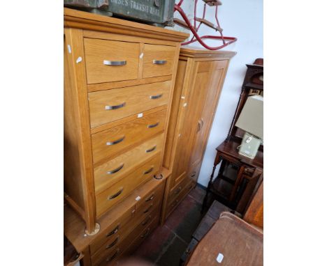 A suite of modern light oak bedroom furniture comprising wardrobe, chest of drawers and tallboy chest of drawers. 