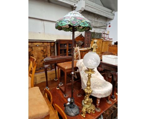 A Tiffany style standard lamp with leaded glass shade. 