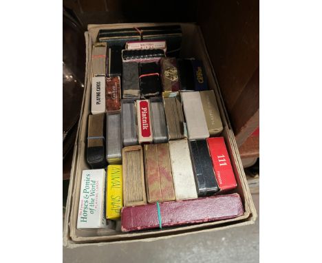 A box containing a collection of vintage playing cards. 
