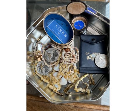 A tin of assorted items including pocket watch movements, a Links of London watch, a £5 coin etc. 