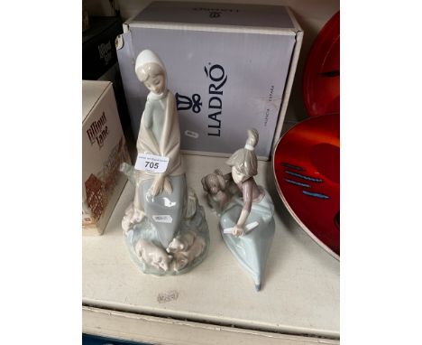 A boxed Lladro figurine, model 5875, girl with dog together with a Nao figurine, woman with pigs. 