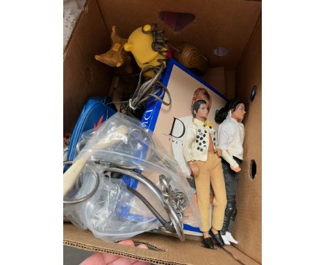A box of miscellaneous items including some horsing related, a rubber snaffle bit, a loop ring jointed snaffle, a horse mouth