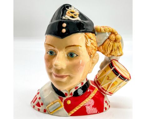 Red, white, black, light brown, and grey coloration. The North Staffordshire Drummer Boy character jug was one of the complim