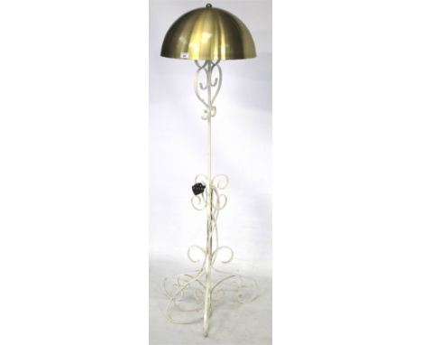 A metal standard lamp. Complete with golden dome shaped shade, H143cm.
