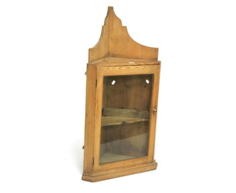 A Victorian pine corner cupboard. With a glazed door opening to reveal a single shelf, L59cm x D40.5cm x H112cm