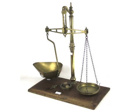 A set of brass Bay &amp; Millward balance scales. Mounted on a mahogany base, H60cm
