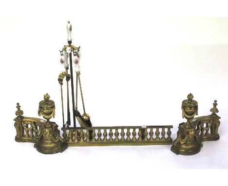 A 20th century fire companion set and gilt metal fender. The tools with ceramic handles decorated with roses, H70cm, the fend