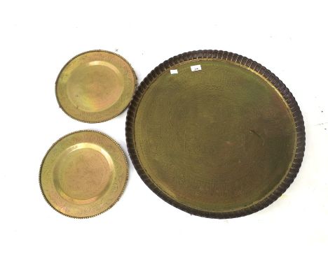 Three vintage Indian brass chargers. All with engraved details, the largest with pressed rim, diameter 62cm