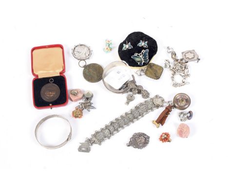 A collection of silver jewellery. Including an engine turned belt bangle, London 1947; a 'Sterling' feather torque bangle, a 