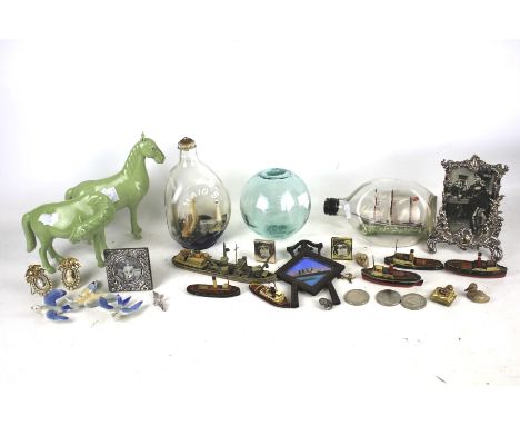 An assortment of collectables. Including a pair of ceramic horses, three ships in bottles, photo frames, etc.
