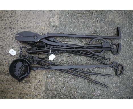 An assortment of vintage black smith and metal smelting tools. Including a welders block L41cm