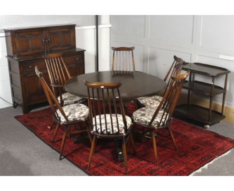 A vintage Ercol dining room suite of furniture. Including an circular extending dining table (diameter 114cm) and six chairs,