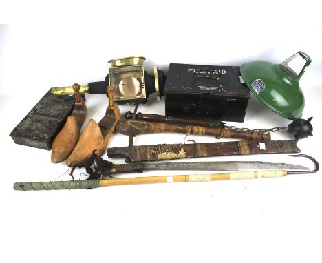 An assortment of collectables. Including tribal weapons, a carriage lamp, enamel shade, shoe stretchers, etc.