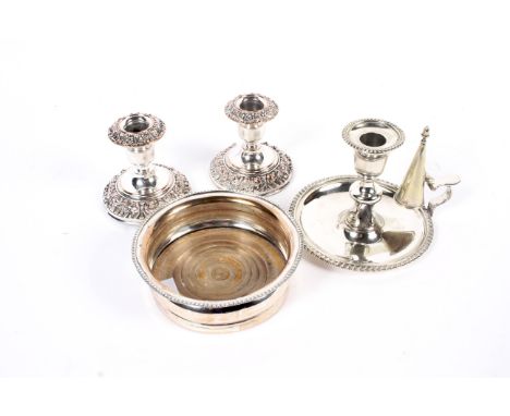 A collection of silver plate. To include a pair of electro-plated-on-copper short round candlesticks with floral embossed noz