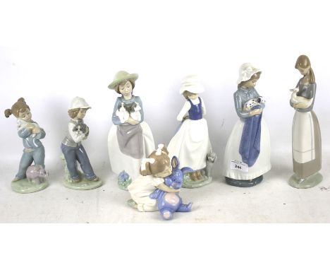 Seven Nao figures. Featuring women and children in a variety of poses, tallest H28cm