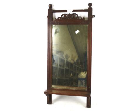 An Edwardian mahogany framed hall mirror. With pierced and carved decoration and small shelf. 33cm x 76cm 