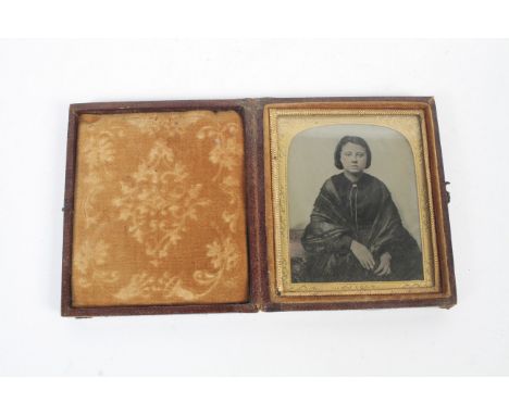 A late Victorian portrait photograph. Mounted behind a chased yellow metal mount and in a folding Morocco case. Case 8cm x 9.