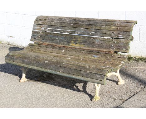 A vintage gargen bench. The cast metal ends painted white, united by multiple planks, L156cm x D80cm x H77cm