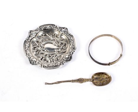 An assortment of silver collectables. to Include a spoon, bangle and silver dish with foliate decoration, hallmarked Birmingh