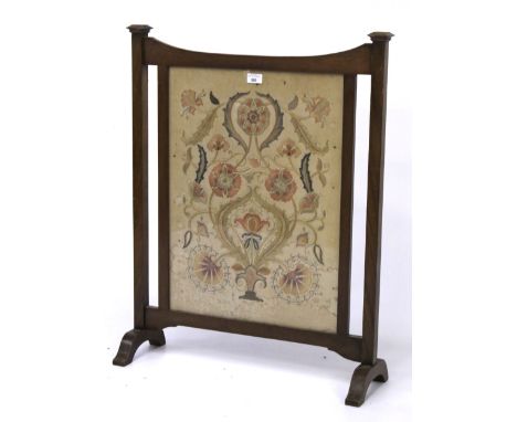 A Victorian oak framed fire screen. The panel featuring a satin stitched floral embroidery, L65cm x D20cm x H82cm