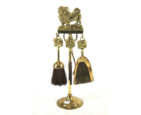 A vintage brass four piece fireside tools set. Topped with a 'Pekingese' dog, H47cm 
