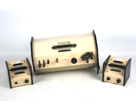 A vintage Bakelite radio and speakers. Coloured pink with black fittings, radio L31cm