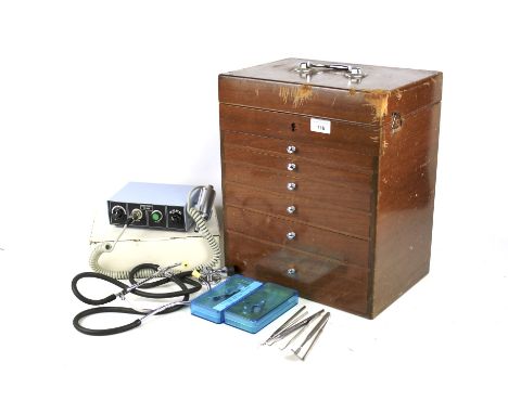 An assortment of medical equipment. Including dentil tools, a minitech, bottles, etc. Some stored within a mahogany box with 