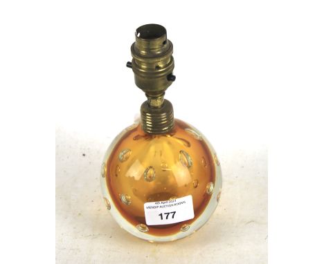 A mid-century globular amber glass lamp base. With bubble inclusions, with brass fittings, H18.5cm Condition Report: Transpar