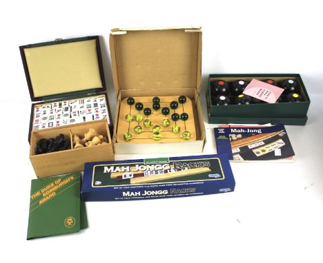 An assortment of vintage family games. Including Stauton chess pieces, a carpet bowls set and a Mah-Jong set, etc.