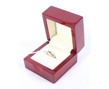A white gold wedding band stamped 750 with continental marks. Size M, 2.6 grams. Condition Report: Ring has some slight wear 