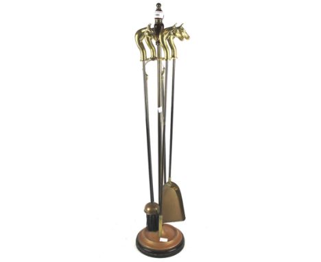 A Victorian fireplace companion set. The tools topped with brass handles modelled as horse heads, H83cm