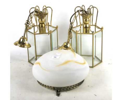 Three contemporary ceiling light fittings. Comprising a pair of brass and clear glass hall lanterns, H34cm, and an Art Deco s