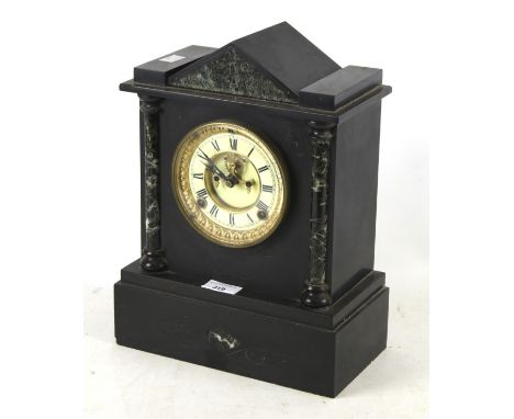 A Victorian black slate mantle clock. American eight day movement, with architectural features including marble columns and p