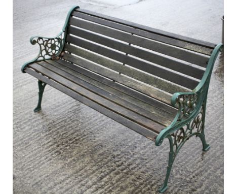 A vintage garden bench. The cast metal ends painted green, with wooden planks, L126cm x D55cm x H70cm