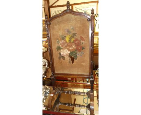 A mid-Victorian rosewood fire screen, with rise and fall action and floral painted canvas inset (with losses and damages)
