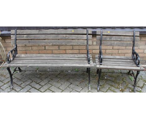 A black painted wrought iron ended and pine slatted two-seater garden bench, width 120cm, together with a single matching gar