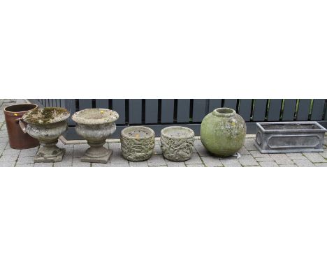 A pair of reconstituted stone footed garden urns, together with a further pair of reconstituted circular garden planters, fur