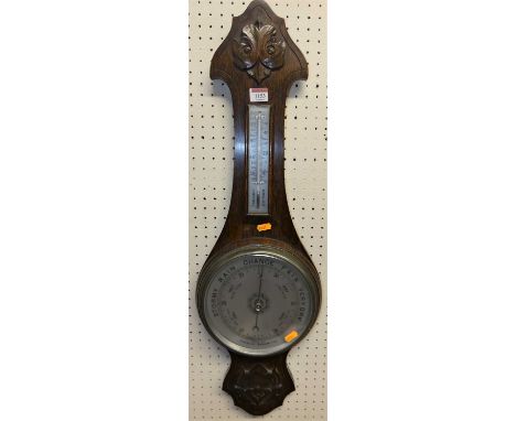 A mid-20th century relief carved oak two-dial aneroid wheel barometer