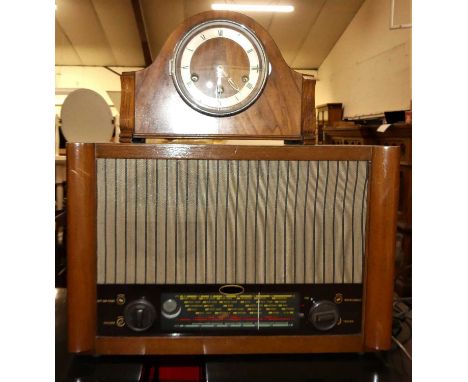 A 1950s walnut cased radio, together with a 1930s figured walnut striking and chiming mantel clock (2)