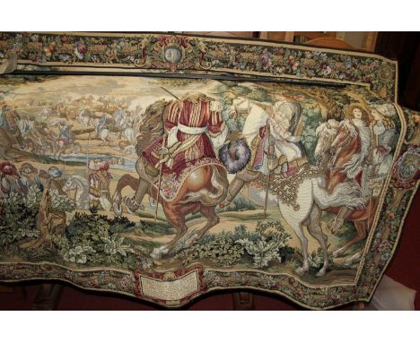 A contemporary Continental embroidered tapestry wall hanging, depicting a medieval French battle scene within a landscape, to