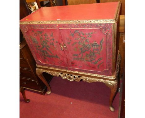 A 1930s and later red painted and gilt decorated double door drinks cabinet, raised on scroll cabriole supports, decorated in