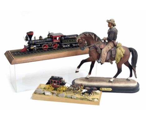 Small scale model of the Wells Fargo U.S postal stagecoach with four horses, mounted on a dust track diorama under a perspex 