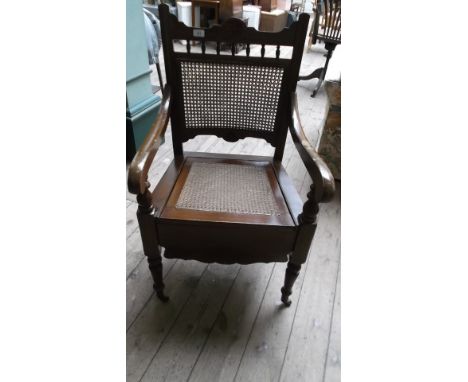 Oak framed commode with cane seat and back, inset pot liner