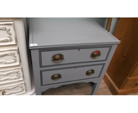 Light blue painted chest of 2 long drawers, each with brass drop handles and oval finger plates