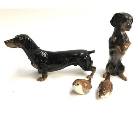 A pair of Rosenthal ceramic daschunds (af), one on hind legs, 19cmH, the other on all fours, 13cmH; A pair of USSR porcelain 