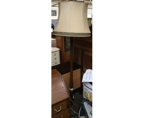 A turned wooden standard lamp with shade 