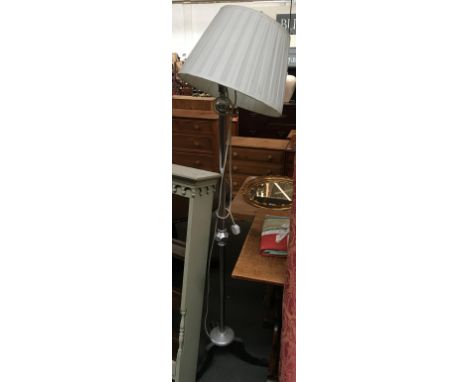 A chrome and steel standard lamp with shade 